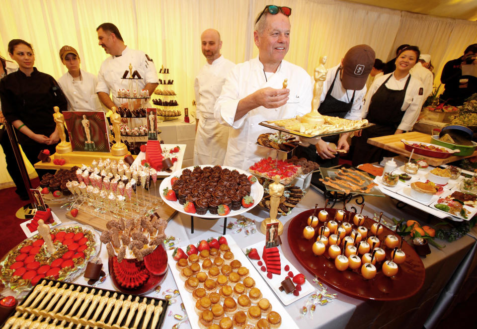 Master Chef Wolfgang Puck holds a tray with 24-karat chocolate as he displays his menu for the 84th Annual Academy Awards Governors Ball during the Oscar food and beverage preview at the Kodak Theatre in Los Angeles on Thursday, Feb. 23, 2012. (AP Photo/Damian Dovarganes)