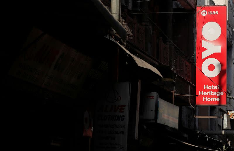 FILE PHOTO: The logo of OYO, India's largest and fastest-growing hotel chain, installed on a hotel building is pictured in an alley in New Delhi