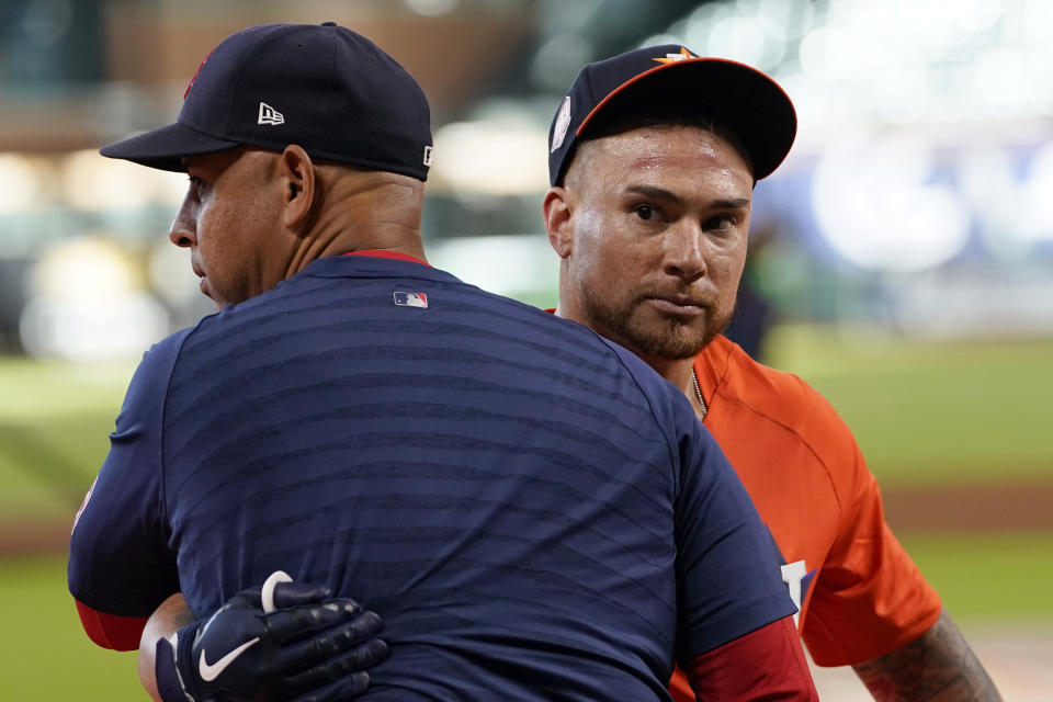 Boston Red Sox manager Alex Cora, left, and Houston Astros' Christian Vazquez hug before a baseball game Tuesday, Aug. 2, 2022, in Houston. Vazquez was traded from the Red Sox to the Astros Monday. (AP Photo/David J. Phillip)