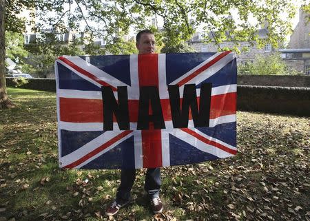 A supporter of the Orange Order holds a Union flag during a pro-Union rally in Edinburgh, Scotland September 13, 2014. REUTERS/Paul Hackett