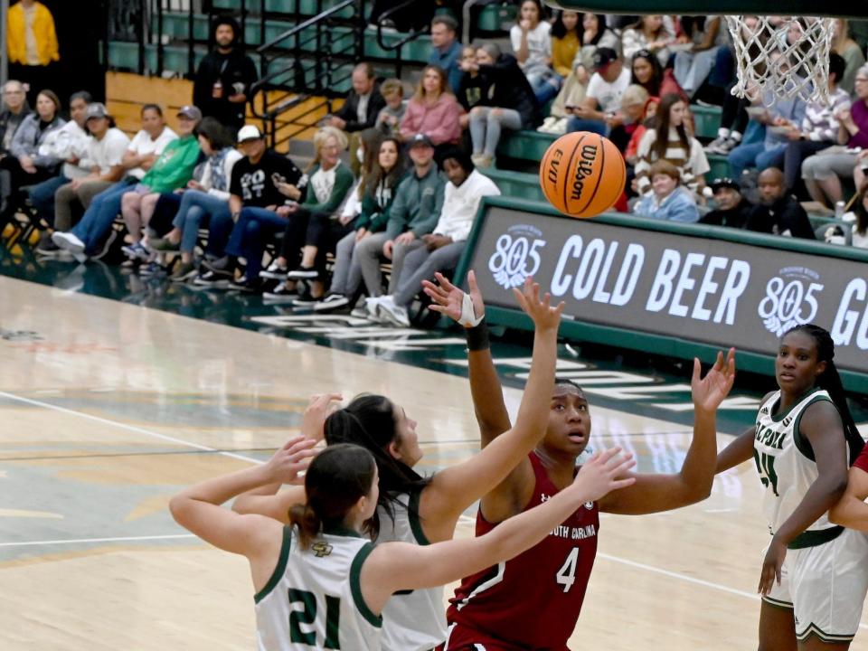 Aliyah Boston shoots over two Cal Poly defenders.