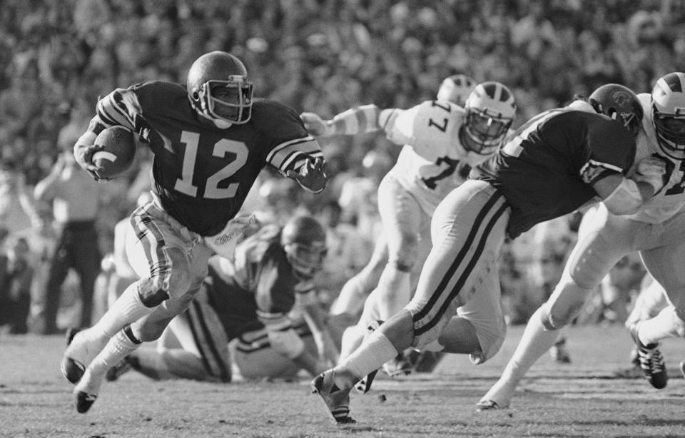 FILE - Southern California tailback Charles White carries against Michigan during the Rose Bowl NCAA college football game in Pasadena, Calif., Jan. 1, 1979. White died Wednesday, Jan. 11, 2023. He was 64. USC announced the death of White, who is still the Trojans' career rushing leader with 6,245 yards. The nine-year NFL veteran died of cancer, the school said. (AP Photo, File)