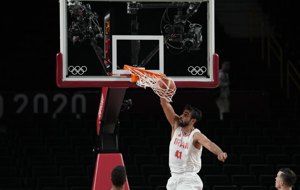 Iran's Arsalan Kazemi (41) scores during men's basketball preliminary round game against France at the 2020 Summer Olympics, Saturday, July 31, 2021, in Saitama, Japan. (AP Photo/Eric Gay)