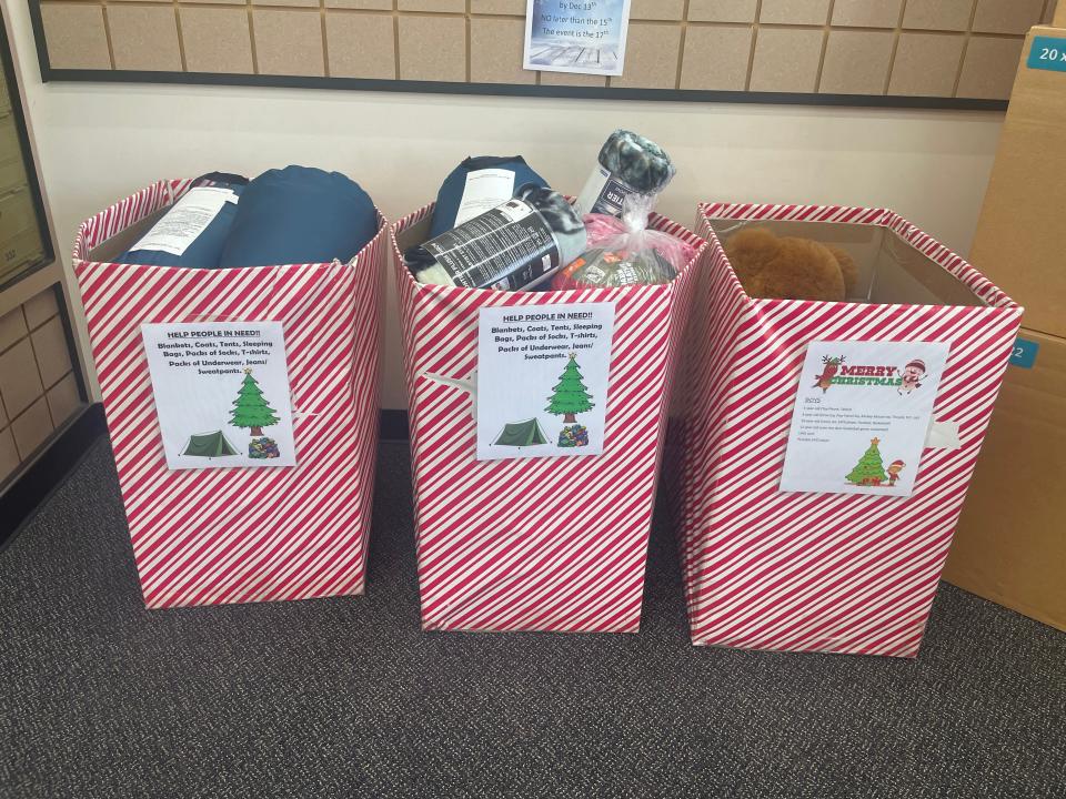 Items fill the drop boxes from the Project Helping Our Homeless and Hungry donation drive at the UPS Store on 23rd Street.