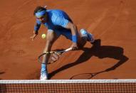 Rafael Nadal of Spain returns the ball to Novak Djokovic of Serbia during their men's quarter-final match during the French Open tennis tournament at the Roland Garros stadium in Paris, France, June 3, 2015. REUTERS/Vincent Kessler