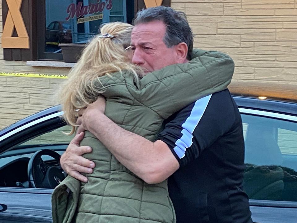 The Original Jumbo's owner Dave Martina commiserates with a friend on Wednesday, May 4, 2022, after a van destroyed his newly opened hot dog stand.