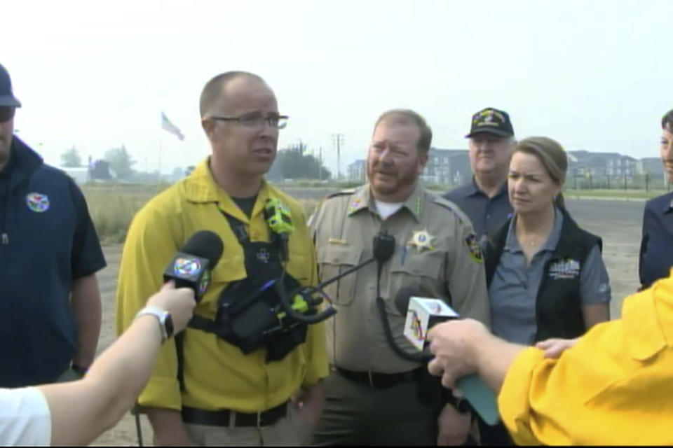 FILE - Spokane County Fire District 3 Chief Cody Rohrbach gives an update on the wildfires on Saturday, Aug. 19, 2023, in Medical Lake, Wash. Authorities say a second person has died in wildfires in eastern Washington state that sparked Friday, burning hundreds of structures and closing a section of a major interstate. Fire officials said Monday, Aug. 21, a body was found in the area of the Oregon fire north of Spokane on Sunday. (KXLY via AP, File)