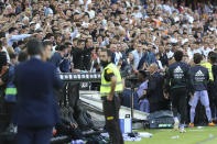 FILE - Real Madrid's Vinicius Junior, center, leaves the pitch after being shown a red card during a Spanish La Liga soccer match between Valencia and Real Madrid, at the Mestalla stadium in Valencia, Spain, Sunday, May 21, 2023. The vicious, relentless and high-profile racist insults directed at Brazilian soccer player Vinícius Junior underscore an entrenched and decades-old issue that refuses to go away in the world's most popular sport. It is a deeper societal problem that is manifested in soccer matches predominantly in Europe, but also all around the world, and has been amplified by the reach of social media. (AP Photo/Alberto Saiz, File)