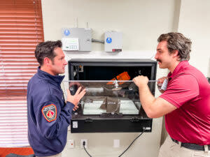 Two firefighters checking a baby box