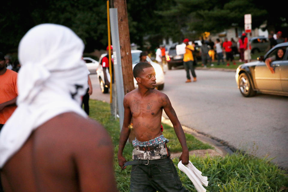 Protesters are forced by police from the Ferguson business district into nearby neighborhoods on Aug.&nbsp;11, 2014.