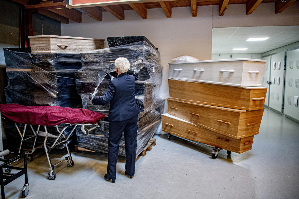 AMSTERDAM, NETHERLANDS - 2020/03/27: An employee of a funeral company arranges coffins in a storage area. Funeral services providers are increasing the production of coffins as they are anticipating a large number of funerals going to take place in the coming weeks as the number of people infected with the COVID-19 Coronavirus increases and the death rate climbs. (Photo by Robin Utrecht/SOPA Images/LightRocket via Getty Images)