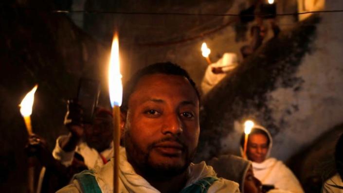 Man holding up a candle/