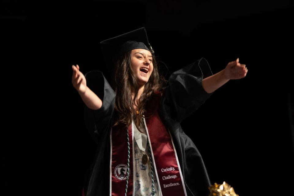 A student blows a kiss out to the audience as she walks across the stage at Bellarmine University’s graduation ceremony on Saturday, May 11, 2024.