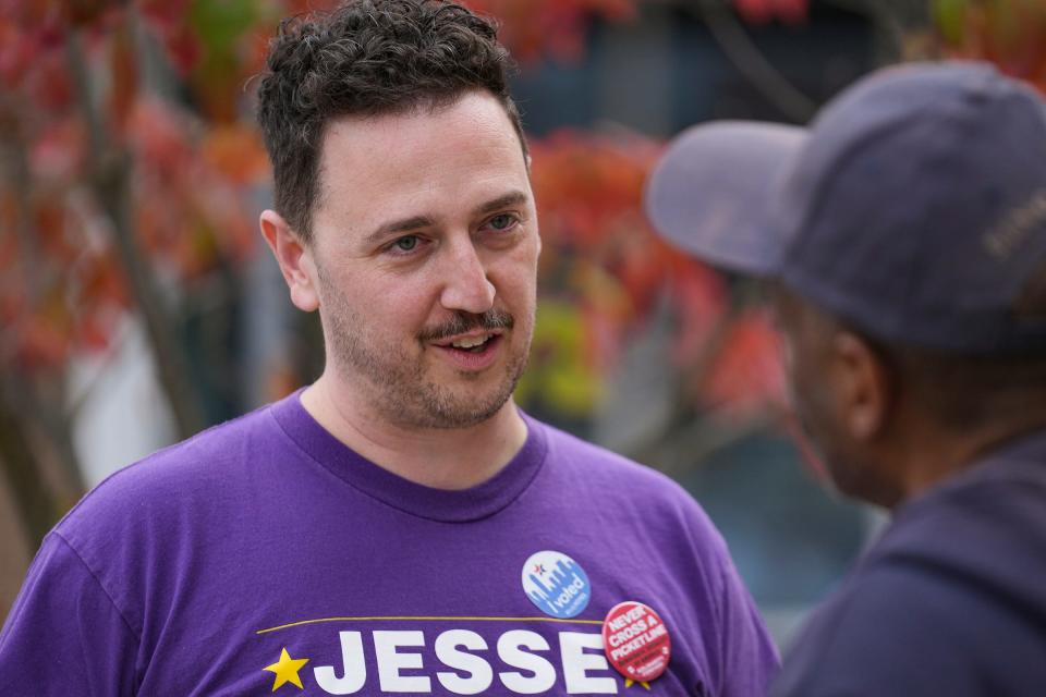 Jesse Brown, the Democratic candidate for Indianapolis City Council District 13, talks to passersby on Election Day, Tuesday, Nov. 7, 2023, outside the John Boner Neighborhood Center in Indianapolis.