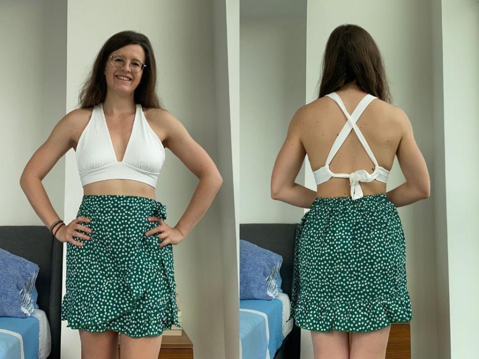 Side by side pictures of a woman facing front and back wearing a white crop trop and a green skirt with white flowers. She smiles at the camera and wears gold glasses.