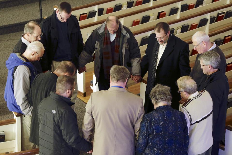 In this Thursday, Feb. 6, 2014 photo, religious leaders of various denominations in Fremont, Neb., pray at the First United Methodist Church, following a service, part of 40 Days of Prayer for Fremont. The prayer and meeting comes ahead of a special election Tuesday, Feb. 11, to decide whether to drop housing restrictions against illegal immigrants, as had been approved by Fremont voters in the 2010 elections. The city leaders scheduled the special election because of concerns the housing restrictions could cost them millions in federal grants and lead to more lawsuits against the city. (AP Photo/Nati Harnik)