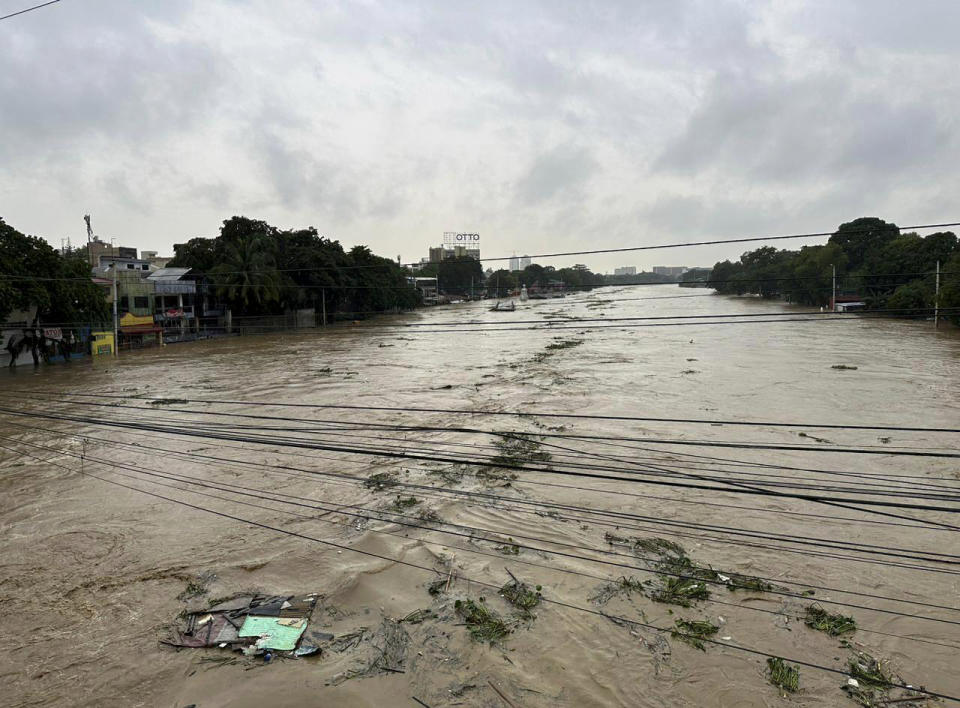 Marikina River swells as monsoon rains worsened by offshore typhoon Gaemi on Wednesday, July 24, 2024, in Manila, Philippines. (AP Photo/Joeal Capulitan)