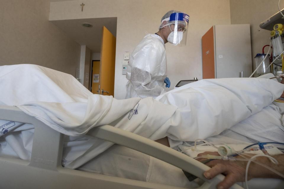 Dr. Gabriele Zanolini director of the main covid ward at Mellino Mellini hospital tends to a patient in the emergency COVID-19 in Chiari, northern Italy, Monday, March 8, 2021. The 160-bed hospital in the Po River Valley town of Chiari has no more beds for patients stricken with the highly contagious variant of COVID-19 first identified in Britain, and which now has put hospitals in Italy’s northern Brescia province on high alert. (AP Photo/Luca Bruno)