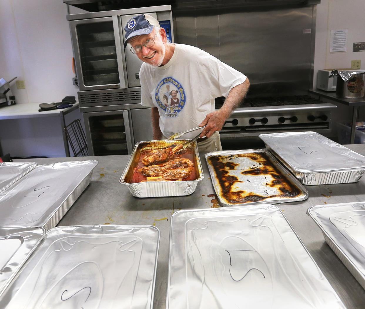 Paul Maskwa has been participating in the Dover Greek Festival for more than 20 years. "We cook 450 pounds of lamb shanks," he says as he turns the meat in a pan Thursday, Sept. 1, 2022. He says the festival will serve 2,500-2,800 people at the Hellenic Center during the Sept. 2-3 event.