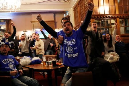 Britain Football Soccer - Leicester City fans watch the Chelsea v Tottenham Hotspur game in pub in Leicester - 2/5/16 Leicester City fans watching the game celebrate after Chelsea's first goal Reuters / Eddie Keogh Livepic
