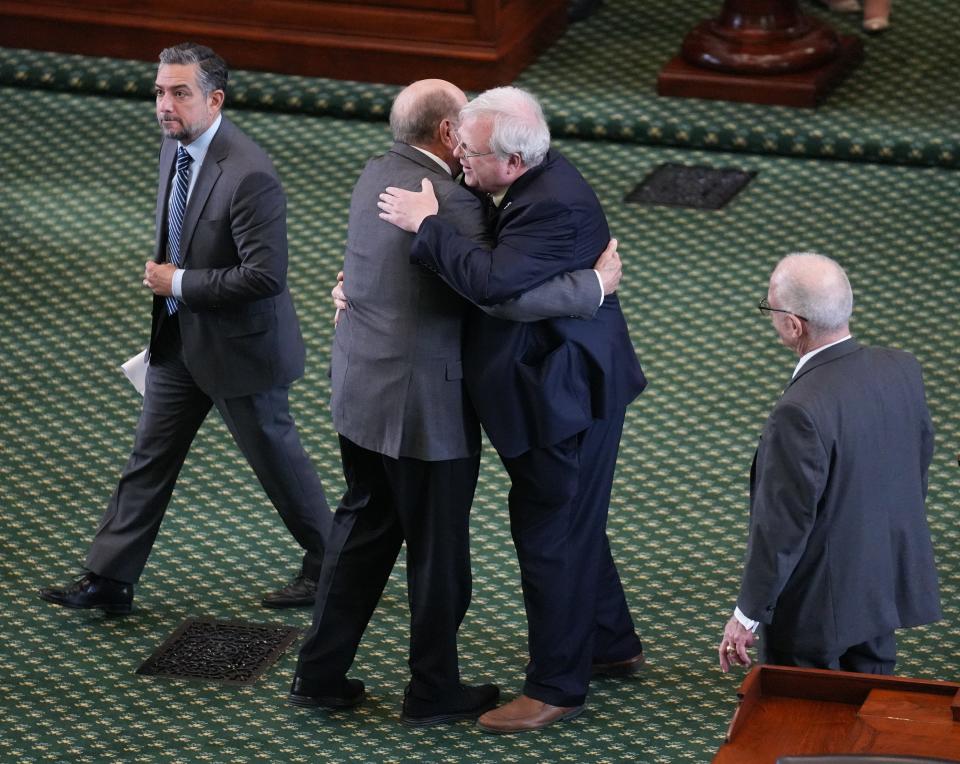 Sen. Paul Bettencourt, R-Houston, right, is congratulated by Sen. Juan “Chuy” Hinojosa, D-McAllen, after the passage of Senate Bill 1, a property tax bill, in the Senate on May 30, the first day of the first special session.