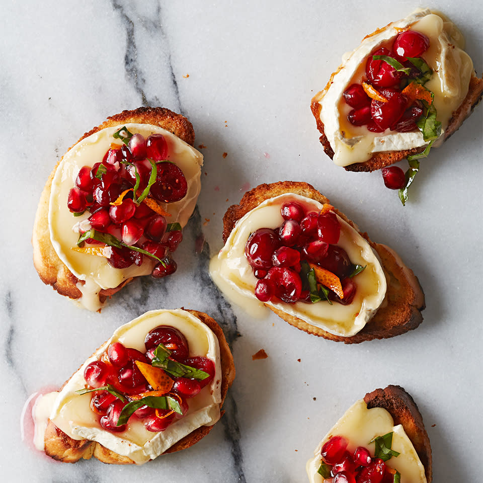 <p>Make this simple festive appetizer for your holiday guests. Toasted baguette slices with creamy, melted brie are topped with an orange-cranberry-pomegranate mixture--each bite delivers an explosion of flavor and texture!</p> <p> <a href="https://www.eatingwell.com/recipe/269209/pomegranate-cranberry-brie-bruschetta/" rel="nofollow noopener" target="_blank" data-ylk="slk:View Recipe" class="link ">View Recipe</a></p>