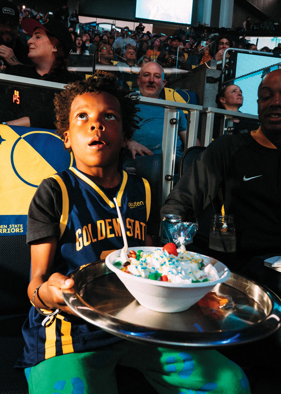 A young Warriors fan gets a sundae delivered on a silver platter at the Chase Center in San Francisco, CA during a game between the Golden State Warriors and Denver Nuggets on Feb 25, 2024.