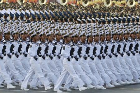 Soldiers of People's Liberation Army (PLA) march in formation past Tiananmen Square before a military parade marking the 70th founding anniversary of People's Republic of China