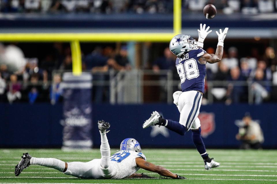 Cowboys wide receiver CeeDee Lamb makes a catch against Lions cornerback Kindle Vildor during the first half at AT&T Stadium in Arlington, Texas on Saturday, Dec. 30, 2023.