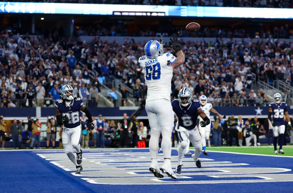 Detroit Lions left tackle Taylor Decker catches a 2-point conversion that was overturned by a penalty late in the fourth quarter against the Dallas Cowboys at AT&T Stadium, Dec. 30, 2023.