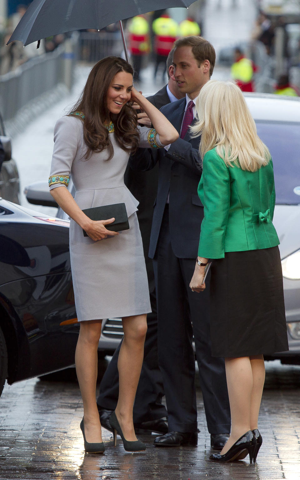 The Duchess of Cambridge is greeted as she arrives under an umbrella for the UK Premiere of 'African Cats', in aid of Tusk Trust, at the BFI Southbank in central London, Wednesday, April 25, 2012. (AP Photo/Joel Ryan)