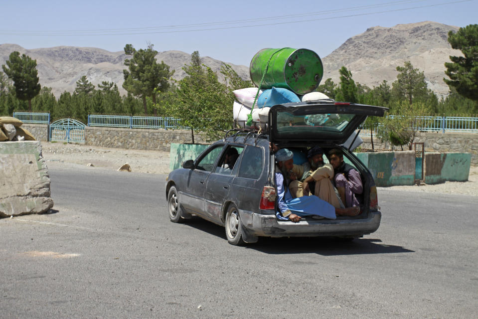 Afghans flees fighting between Taliban and Afghan security forces, on the outskirts of Herat, 640 kilometers (397 miles) west of Kabul, Afghanistan, Sunday, Aug. 8, 2021. (AP Photo/Hamed Sarfarazi)