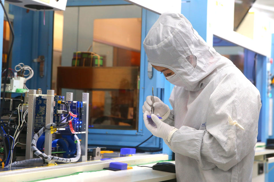 JIASHAN, CHINA - MAY 25: Employees work on the production line of silicon wafer at a factory of GalaxyCore Inc. on May 25, 2021 in Jiashan County, Jiaxing City, Zhejiang Province of China. (Photo by Guo Junfeng/VCG via Getty Images)