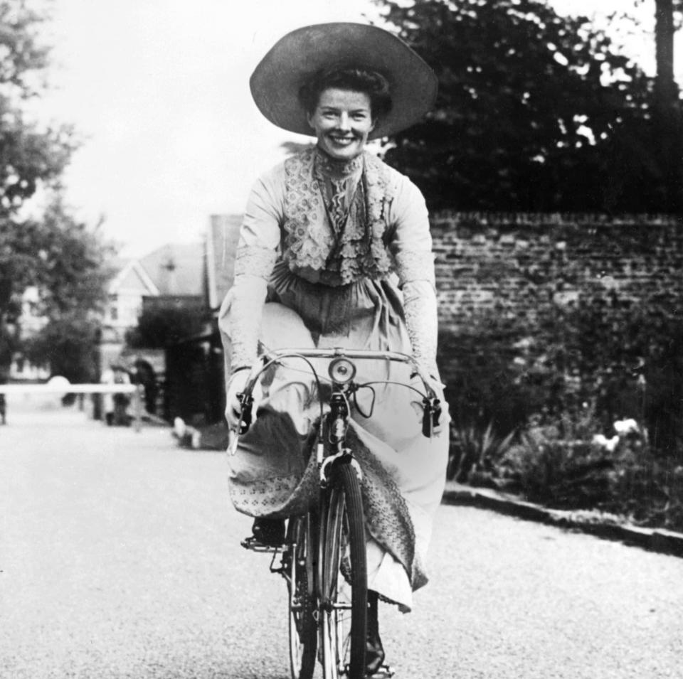 Hepburn rides a bicycle between takes on the set of The African Queen - AFP