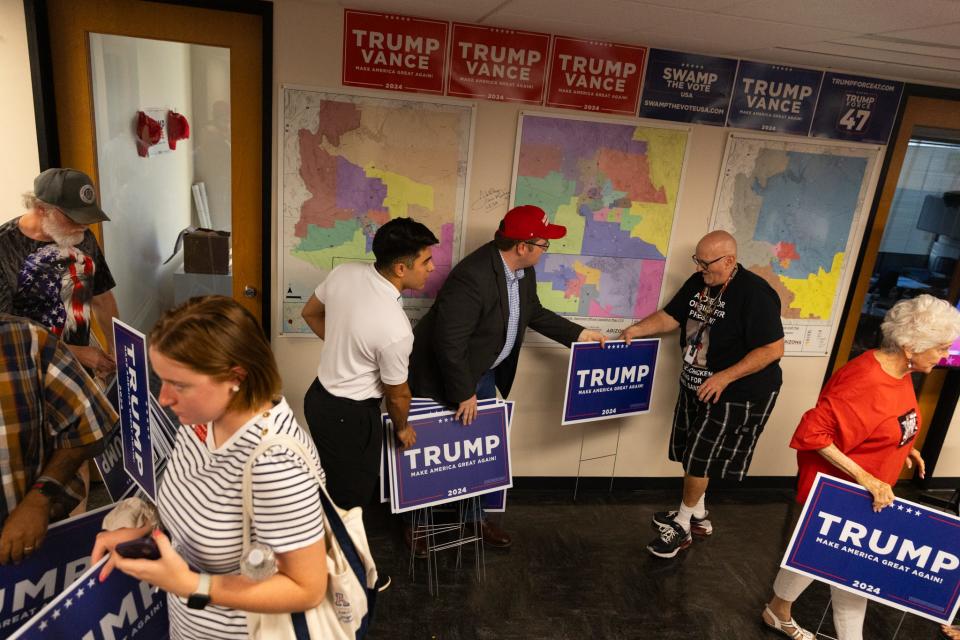 Members of Team Trump hand out lawn signs on July 18, 2024, in Phoenix, Arizona.