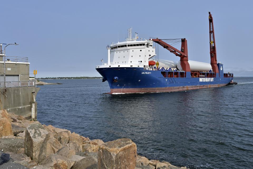 The ship UHL Felicity, carrying wind turbine tower sections, arrives at the hurricane barrier, Wednesday, May 24, 2023, to dock in New Bedford, Mass. Once assembled by developer Vineyard Wind, the turbines at sea will stand more than 850 feet high. (AP Photo/Josh Reynolds)