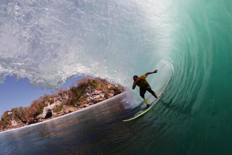 Fabrizio Passetti, 41, surfs in an undated photo. He is competing in the International Surfing Association Para Surf Championship in Huntington Beach this week after getting a new prosthetic leg in Ventura,