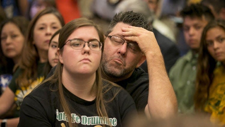 Steve Johnson gets emotional during a roundtable discussion about guns in schools led by Gov. Greg Abbott at the Capitol on May 24. Johnson is sitting with his daughter, Grace Johnson, a Santa Fe High School student. JAY JANNER / AMERICAN-STATESMAN