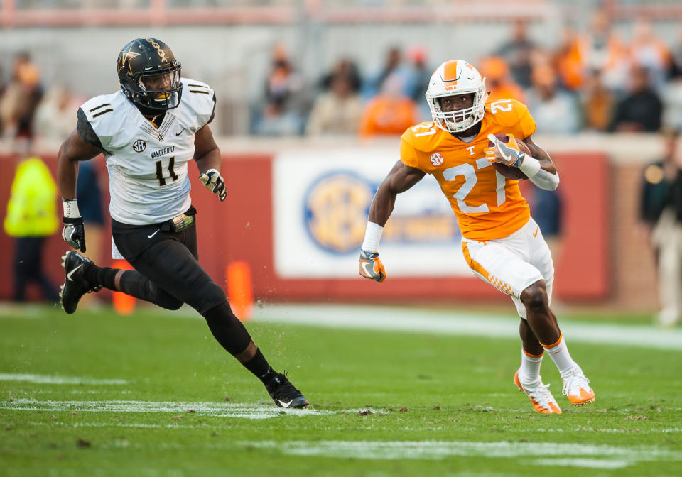 KNOXVILLE, TN - NOVEMBER 25: Tennessee Volunteers running back Carlin Fils-aime (27) runs past Vanderbilt Commodores linebacker Charles Wright (11) during a game between the Vanderbilt Commodores and Tennessee Volunteers  on November 25, 2017, at Thompson-Boling Arena in Knoxville, TN. (Photo by Bryan Lynn/Icon Sportswire via Getty Images)