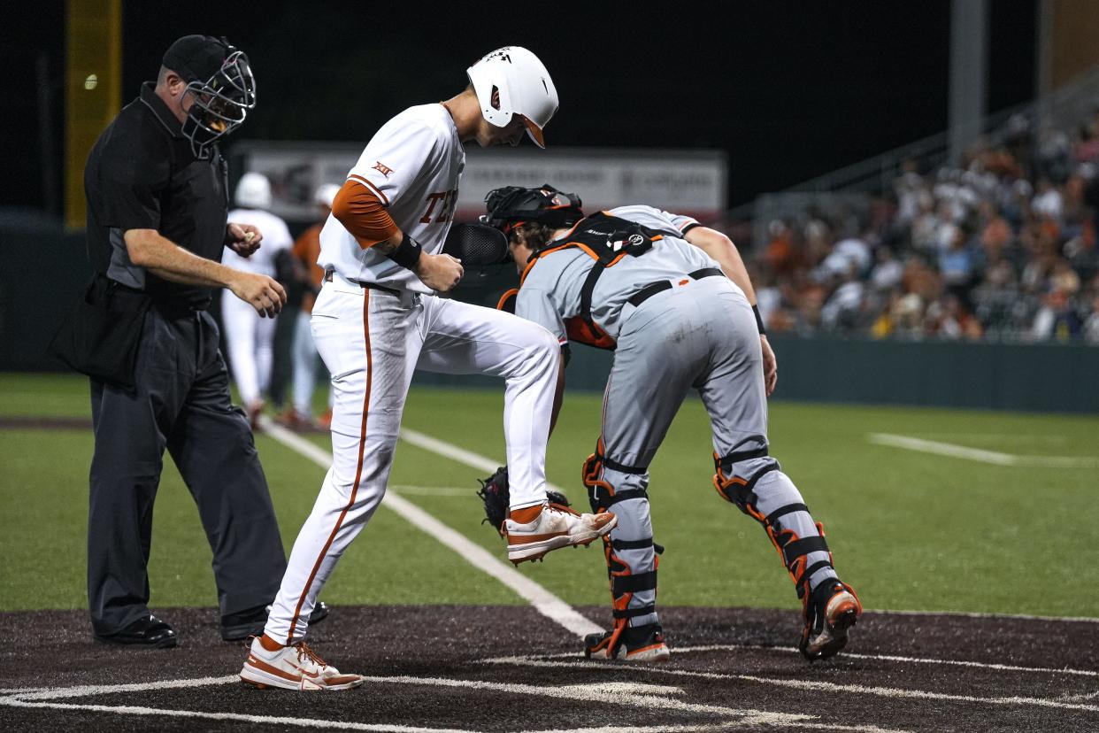 Texas Longhorns infielder Jared Thomas (9) stomps on home plate for a score during the game against Oklahoma State at UFCU Disch–Falk Field on Friday, May. 3, 2024 in Austin.