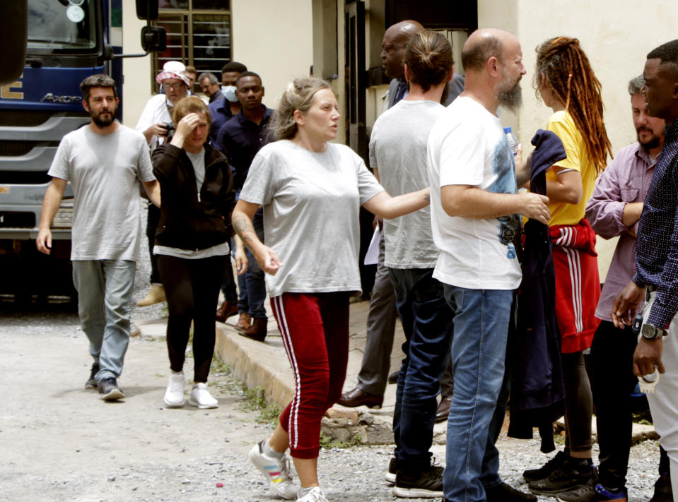 Seven of the eight Croatian nationals charged with attempting to traffic children, outside the magistrates court in Ndola, Zambia, Tuesday, Jan. 10, 2023. The 8 have pleaded not guilty to the charge of child trafficking before a magistrate. (AP Photo/Salim Dawood)