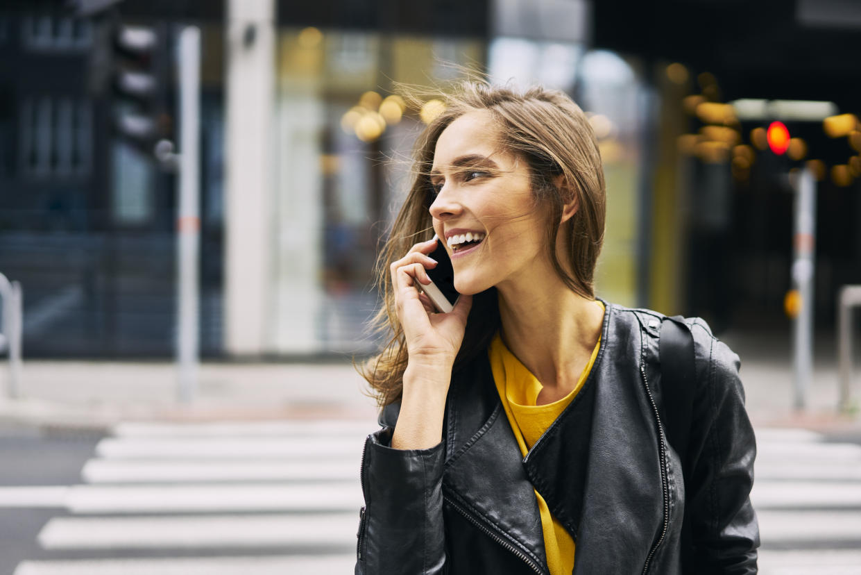 Woman using a mobile phone, as experts say they can cause acne. (Getty Images)