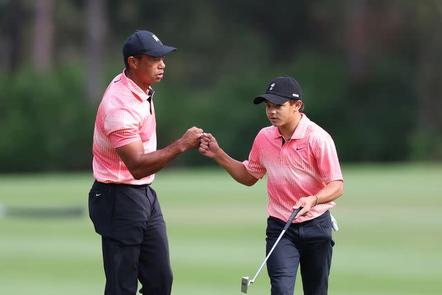 <p>Mike Ehrmann/Getty</p> Tiger Woods of the United States and son Charlie Woods celebrate on the sixth green during the first round of the PNC Championship at Ritz-Carlton Golf Club on December 17, 2022 in Orlando, Florida.