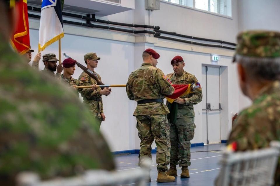 Maj. Gen. Pat Work, commander of the 82nd Airborne Division and "Task Force 82", and Command Sgt. Maj. Randolph Delapena, uncase the division colors during a Dec. 15, 203, transfer of authority ceremony hosted by the U.S. Army’s V Corps at Mihail Kogalniceanu Air Base, Romania.