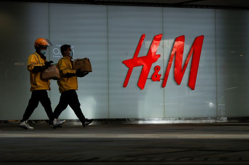 FILE PHOTO: People walk past an H&M store in a shopping area in Beijing