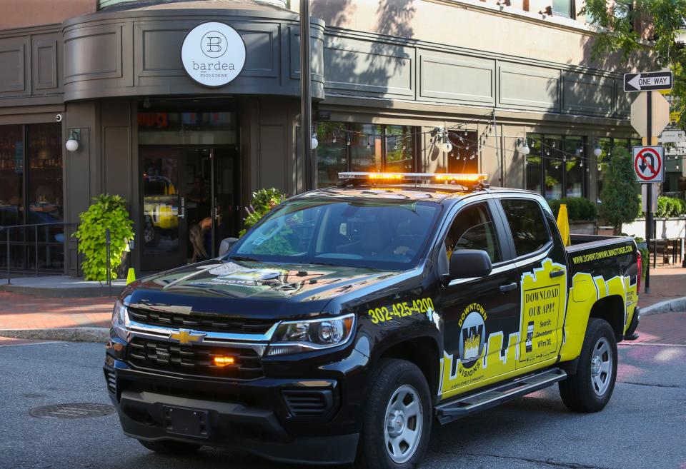 A Downtown Visions vehicle moves past Bardea on Market Street in downtown Wilmington, Tuesday, Sept. 19, 2023.