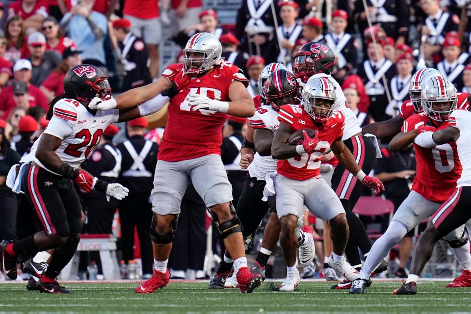 Ohio State tackle Josh Fryar blocks for running back TreVeyon Henderson against Western Kentucky.