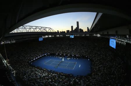 Tennis - Australian Open - Melbourne Park, Melbourne, Australia - 28/1/17 Sunset is seen from Rod Laver Arena as Serena Williams of the U.S. serves during her Women's singles final match against Venus Williams of the U.S. .REUTERS/Jason Reed