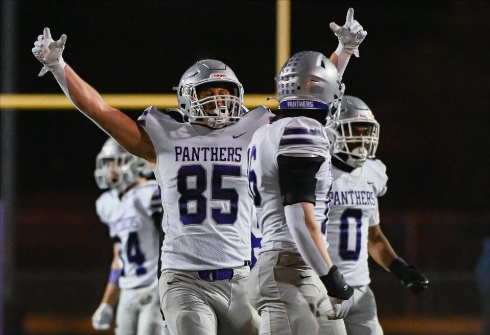 Bloomington South’s Tysen Smith (85) celebrates with Ben Godar after a sack by Godar during the IHSAA sectional championship football game at Seymour on Friday, Nov. 3, 2023.