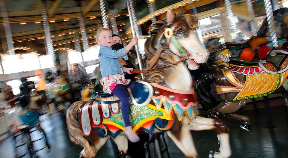 Mom Lindsay Sampson, of Rockland, and 3-year-old daughter Aubrey take the first ride of the year. Mother's Day is the traditional opening of the Paragon Carousel in Hull. The 1928 carousel, run by the Friends of the Paragon Carousel, has 66 horses for kids to ride.